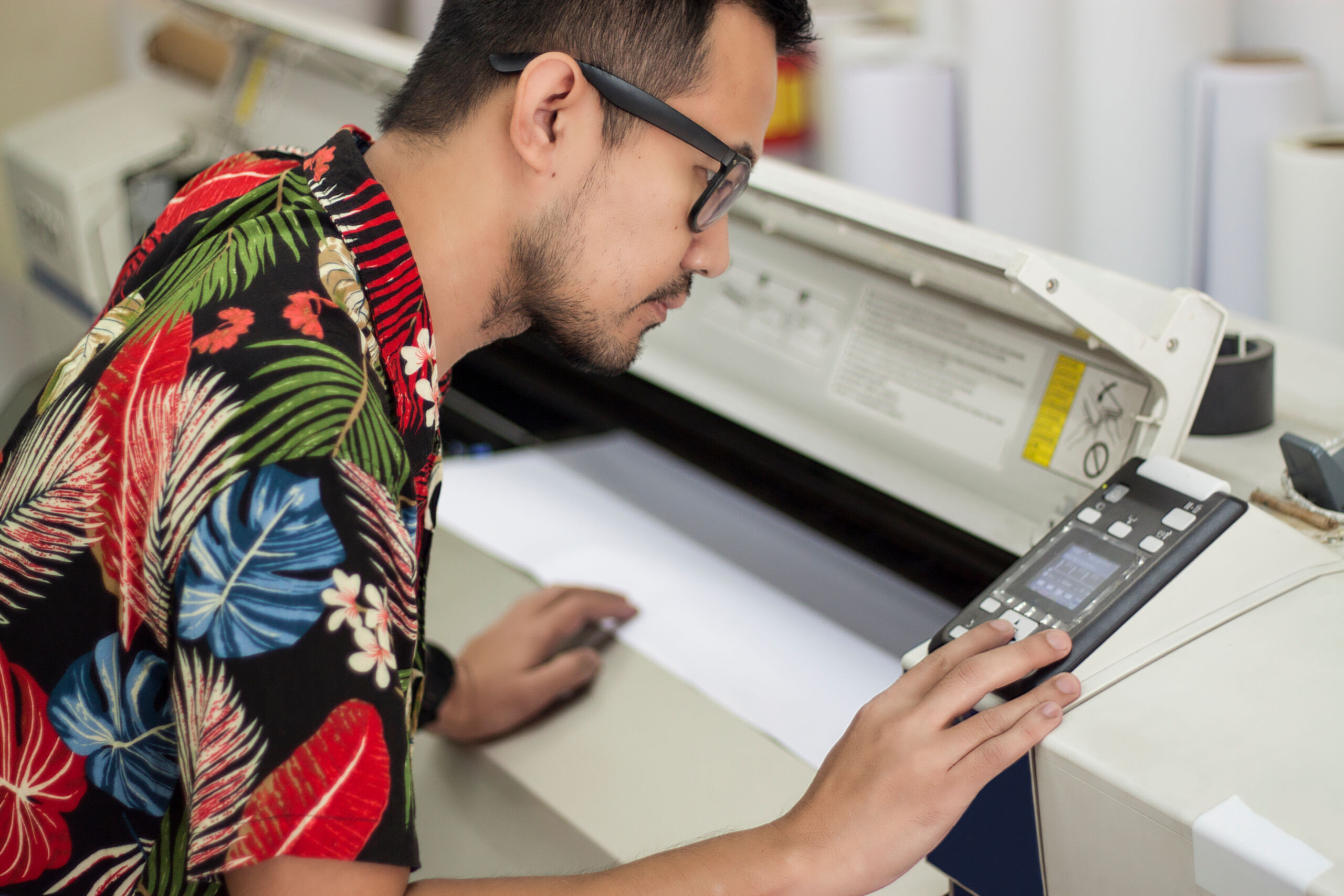 Asian,Male,Employee,Checking,The,Printer,For,Printing,For,Delivering